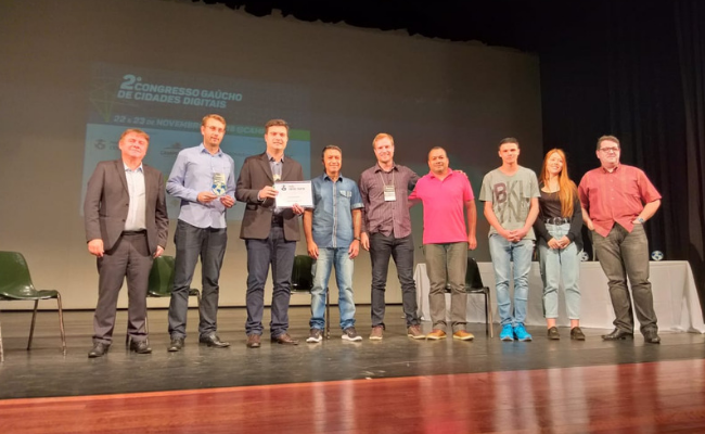 Em um palco, com oito pessoas em pé